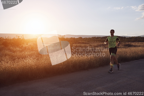 Image of triathlon athlete running on morning trainig