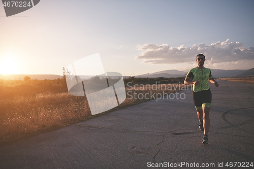 Image of triathlon athlete running on morning trainig