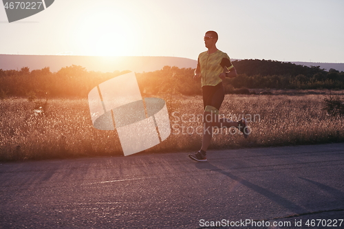 Image of triathlon athlete running on morning trainig