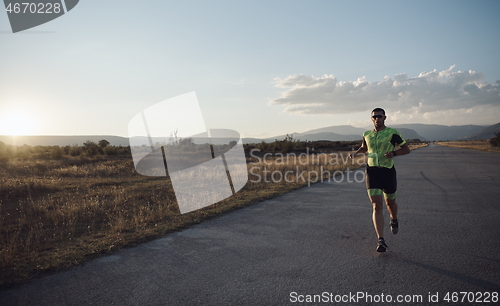 Image of triathlon athlete running on morning trainig