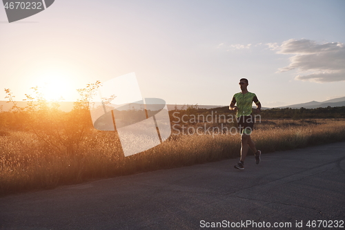 Image of triathlon athlete running on morning trainig