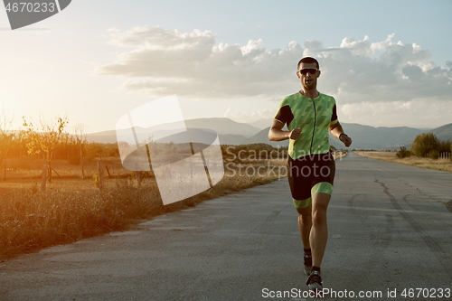 Image of triathlon athlete running on morning trainig