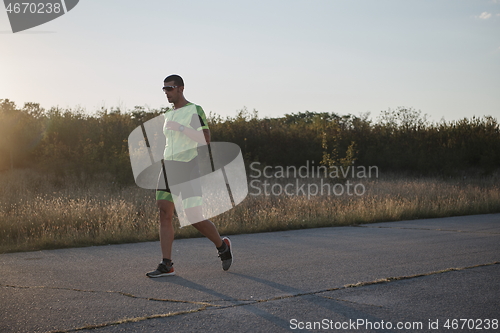 Image of triathlon athlete running on morning trainig