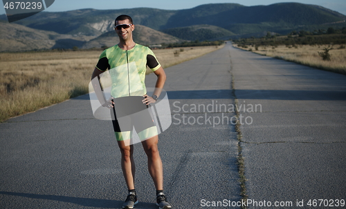 Image of triathlon athlete resting and setting smartwatch