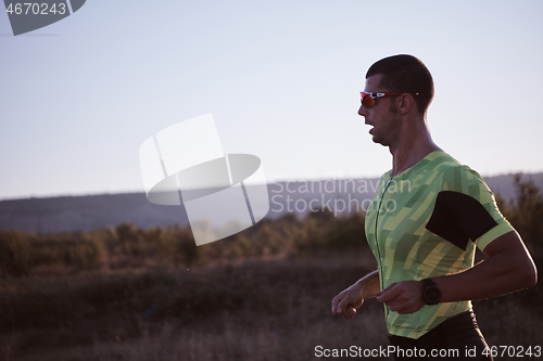 Image of triathlon athlete running on morning trainig