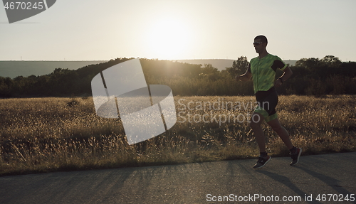 Image of triathlon athlete running on morning trainig