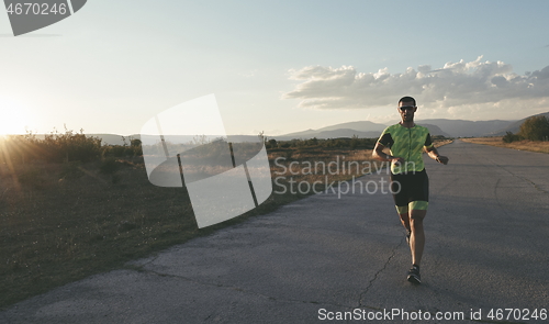 Image of triathlon athlete running on morning trainig