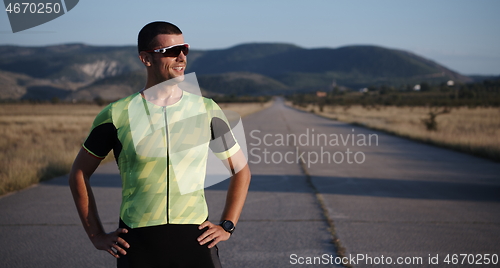 Image of triathlon athlete resting and setting smartwatch