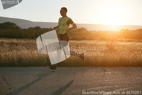 Image of triathlon athlete running on morning trainig