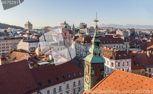 Image of Scenic panoramic aerial drone view of rooftops of medieval city center, town hall and cathedral church in Ljubljana, capital of Slovenia, at sunset