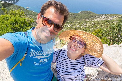 Image of Beautiful, romantic caucasian couple taking selfie self portrait photo on summer vacations on Adriatic coast of Croatia