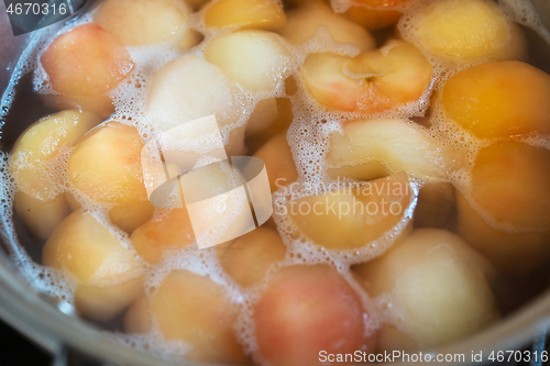 Image of peeled boiled apples in a sugar syrup