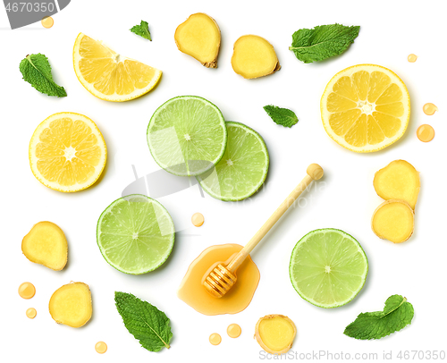 Image of honey spoon, ginger and citrus fruit slices