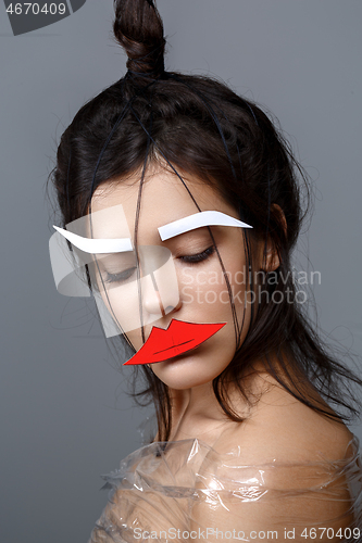 Image of Beautiful girl with applique on face