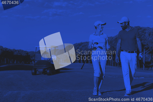 Image of couple walking on golf course