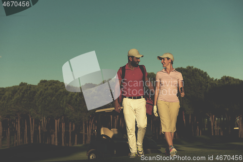 Image of couple walking on golf course