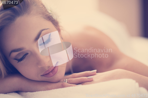 Image of woman getting back massage in spa salon