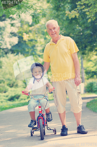 Image of happy grandfather and child in park