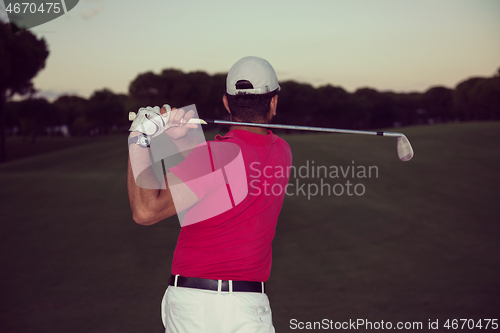 Image of golfer hitting a sand bunker shot on sunset