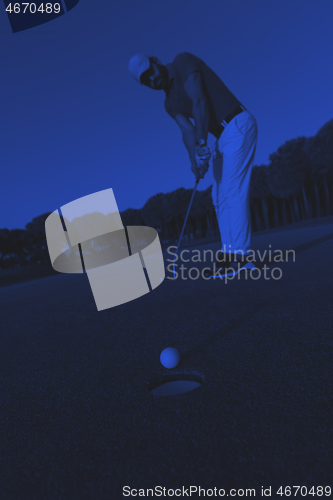 Image of golfer  hitting shot at golf course