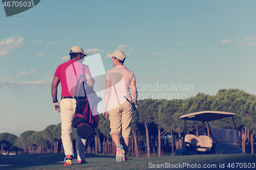 Image of couple walking on golf course