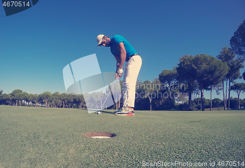 Image of golf player hitting shot at sunny day