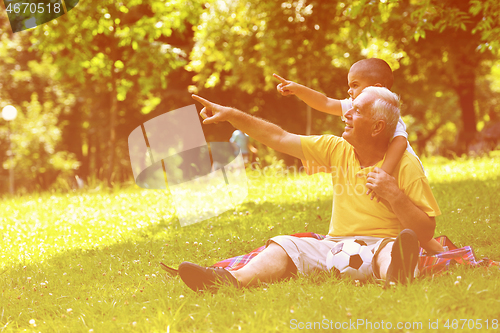 Image of happy grandfather and child in park