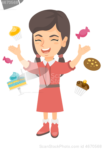 Image of Happy caucasian girl standing among lots of sweets