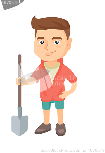 Image of Caucasian smiling boy holding a shovel.