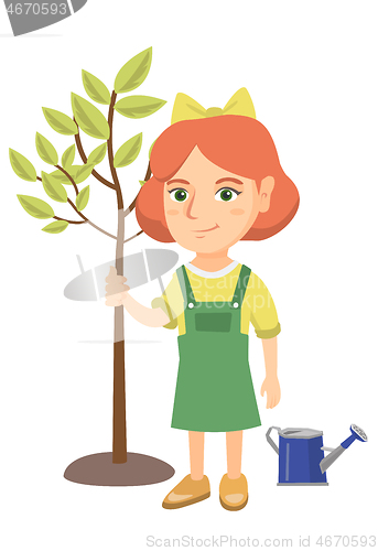 Image of Caucasian smiling girl planting a tree.