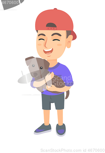 Image of Caucasian happy boy in a cap holding a dog.