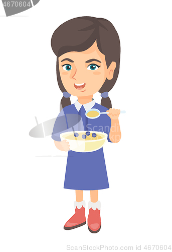 Image of Happy girl holding a spoon and bowl of porridge.