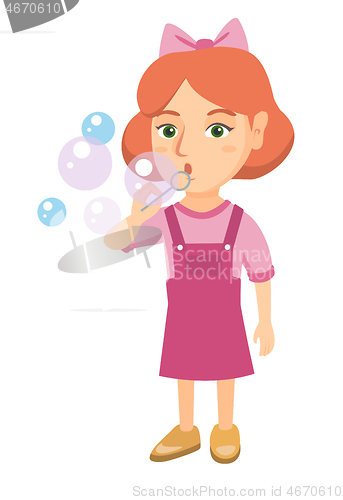 Image of Little caucasian girl blowing soap bubbles.