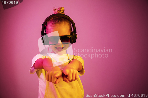 Image of Young girl with headphones enjoying music