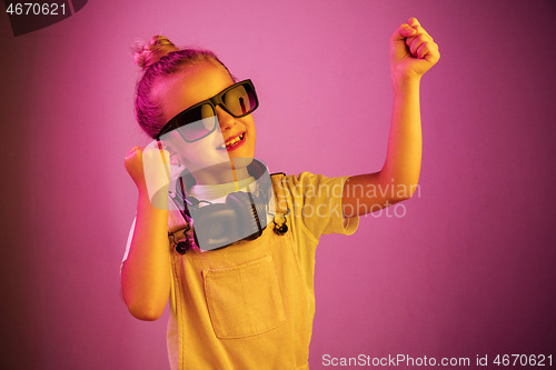 Image of Young girl with headphones enjoying music