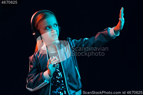 Image of Young girl with headphones enjoying music