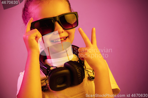 Image of Young girl with headphones enjoying music
