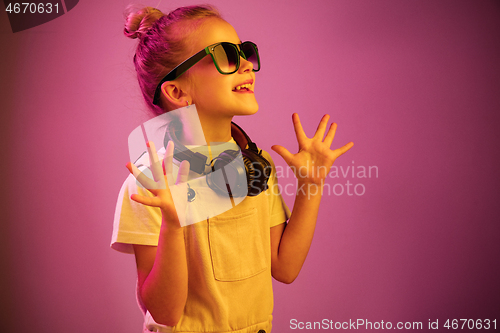 Image of Young girl with headphones enjoying music