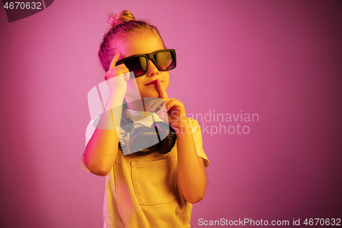 Image of Young girl with headphones enjoying music
