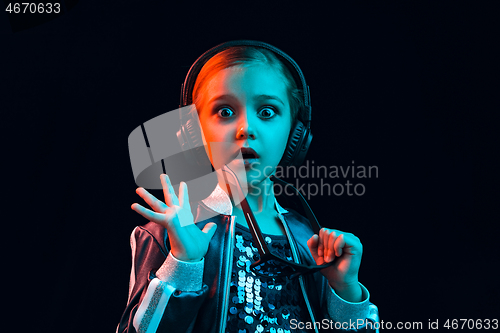 Image of Young girl with headphones enjoying music