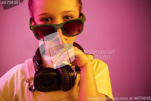 Image of Young girl with headphones enjoying music