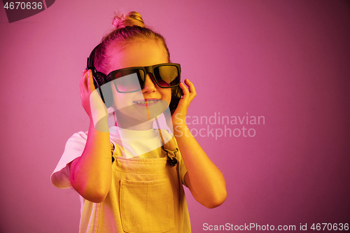 Image of Young girl with headphones enjoying music