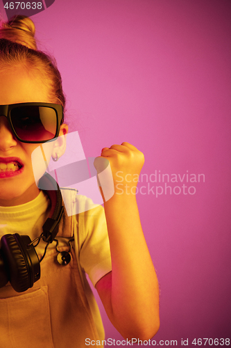 Image of Young girl with headphones enjoying music