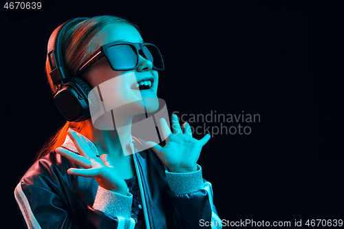 Image of Young girl with headphones enjoying music