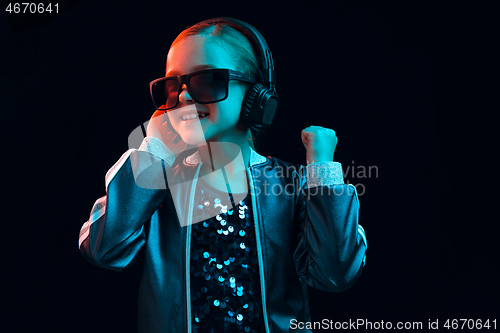 Image of Young girl with headphones enjoying music