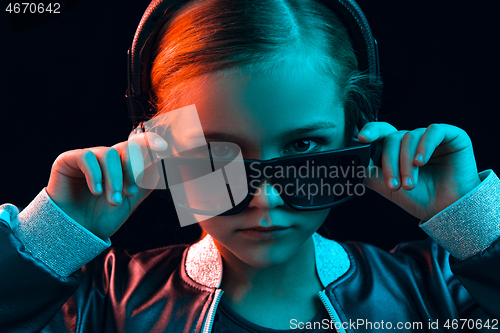 Image of Young girl with headphones enjoying music