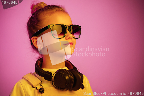 Image of Young girl with headphones enjoying music