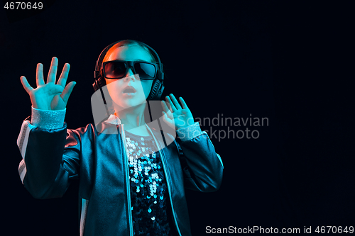 Image of Young girl with headphones enjoying music