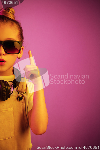 Image of Young girl with headphones enjoying music