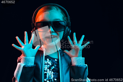 Image of Young girl with headphones enjoying music